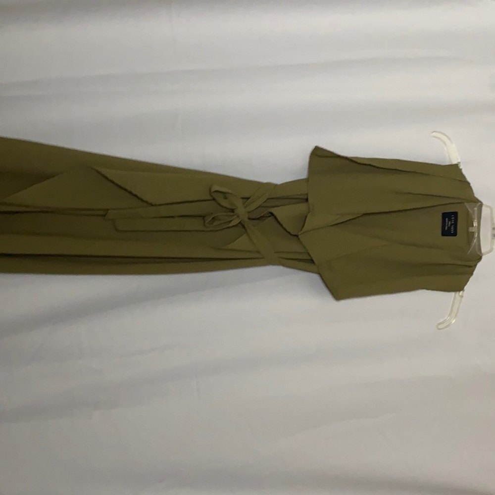 Long green sleeveless cardigan.